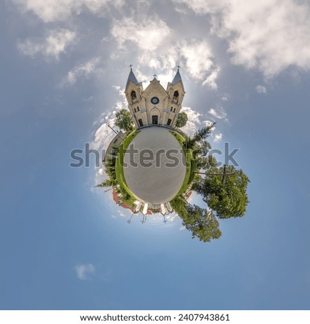 little planet transformation of spherical panorama 360 degrees overlooking church in center of globe in blue sky. Spherical abstract aerial view with curvature of space. Royalty-Free Stock Photo #2407943861