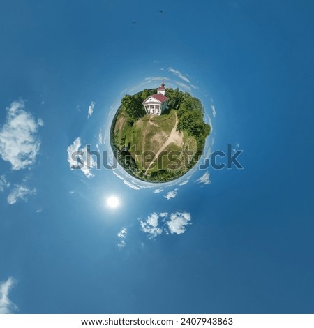 little planet transformation of spherical panorama 360 degrees overlooking church in center of globe in blue sky. Spherical abstract aerial view with curvature of space. Royalty-Free Stock Photo #2407943863