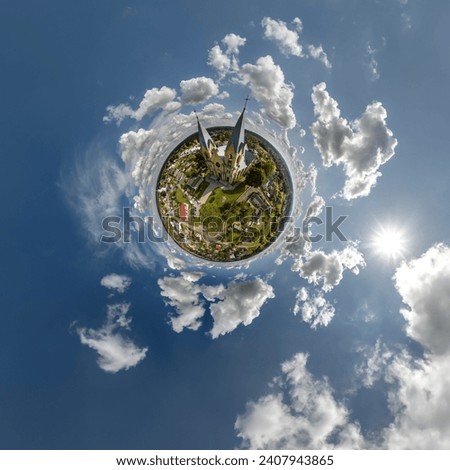 little planet transformation of spherical panorama 360 degrees overlooking church in center of globe in blue sky. Spherical abstract aerial view with curvature of space. Royalty-Free Stock Photo #2407943865