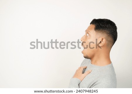 surprised, shocked expression of Asian Man, with his mouth open and wide open eyes, isolated background