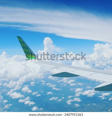 Picture the clouds and sky from inside the airplane window