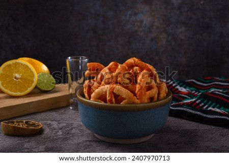 Fried Mexican wheat chips with hot sauce. Duritos, typical Mexican snack. Royalty-Free Stock Photo #2407970713