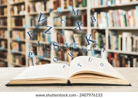 Open book with letters flying out of it in library