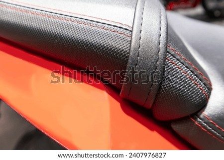 view of a leather motorcycle. macro picture. ,natural suede leather background with an abstract texture