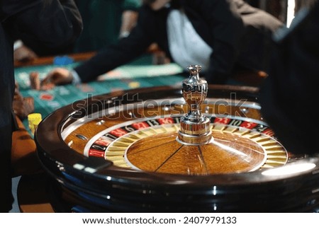 Close-up of a spinning roulette wheel at the casino, capturing the thrill of betting. Royalty-Free Stock Photo #2407979133