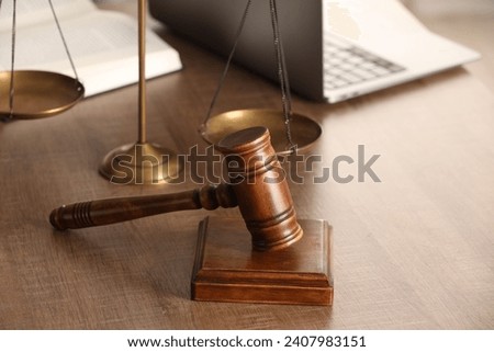 Law concept. Gavel, scales of justice, book and laptop on wooden table