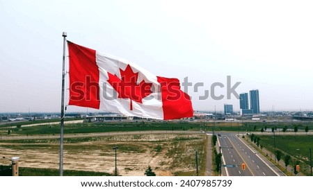 Flag of Canada on sky background in close-up fluttering in wind symbol of national borders freedom Canada flag on flagpole exemplifies patriotism uniqueness. Canada flag represents national identity.