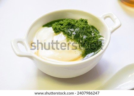 Greek yogurt and wolffia globosa in ceramic bowl isolated on white table background. Wolffia is the nutrient-rich plant-based source of protein and omega3 and vital minerals. Healthy and easy meal.