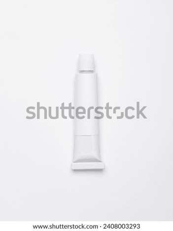 White empty tube of acrylic or oil paint for creativity on white background. Template for design, mockup