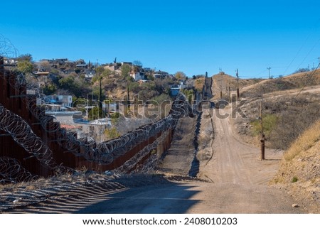 United States Mexico Border Wall between Nogales Arizona and Nogales Sonora on International Street in city of Nogales, Arizona AZ, USA. 
