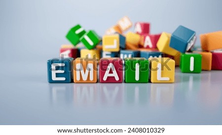 The word email is written on colorful cubes on a gray background