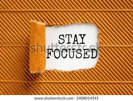 Stay focused symbol. Concept words Stay focused on beautiful white paper on a beautiful brown paper background. Business, support, motivation, psychological stay focused concept. Copy space
