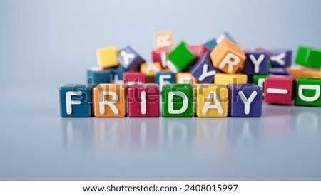 The word Friday is written on colorful cubes on a gray background