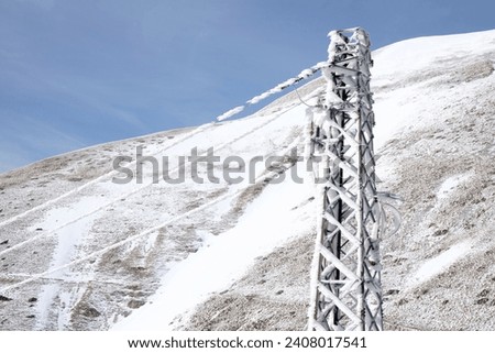 electrical wires with frozen ice on them in mountainous areas
