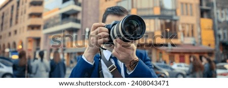 Man photographer taking photo with digital camera