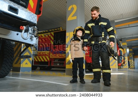 Firefighter holding child boy to save him in fire and smoke,Firemen rescue the boys from fire. Royalty-Free Stock Photo #2408044933
