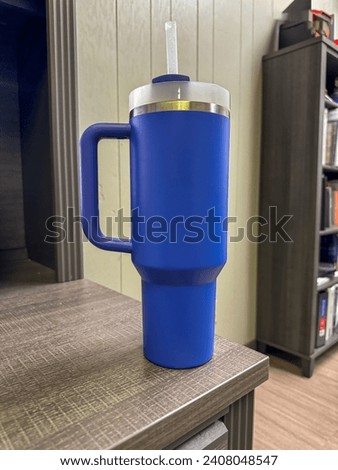 Beautiful double walled insulated cup like a Stanley in an office setting Royalty-Free Stock Photo #2408048547