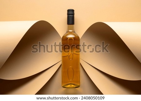 Bottle of white wine on a beige background. Top view. Copy space.