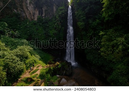 Aerial view of Coban Talun waterfall during an afternoon in East Java, Indonesia