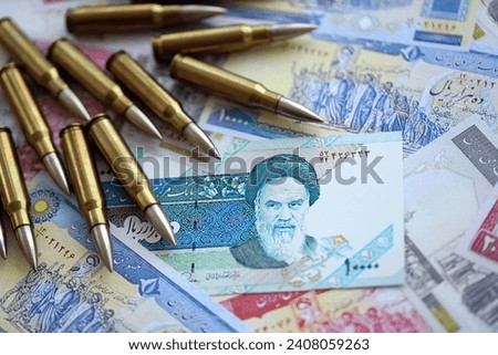Many bullets and iranian rials money bills close up. Concept of terrorism funding or financial operations to support war in Iran Royalty-Free Stock Photo #2408059263