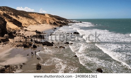 The ocean with its shades of colors in Jeriocoacoara in Brazil, the beach of Pedra Furada, the sand dunes and the long rocky coast
