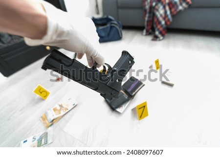 Close up on hands of unknown man forensic police investigator collecting evidence in the plastic bag at the crime scene investigation Royalty-Free Stock Photo #2408097607