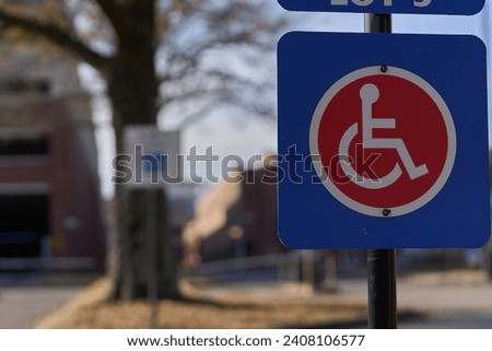 A Handicap Sign in Focus in the Foreground and another Handicap Sign out of Focus in the background 