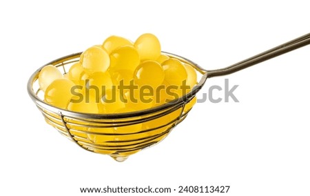 yellow jelly balls for making bubble tea in strainer isolated on white background