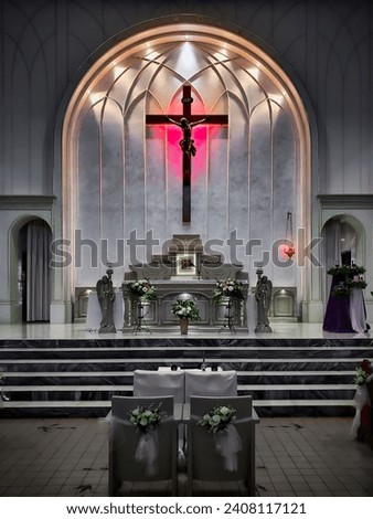 Picture of a Catholic Church taken from the Aisle facing towards the Alter