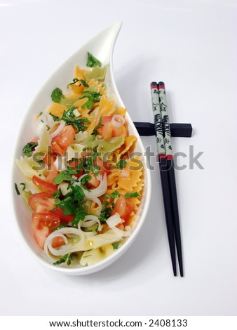 pasta salad on white bowl with stone decoration