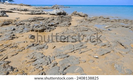 Tanjung Kalian's Tropical Beach With Rocks Worn Away By Sea Erosion Royalty-Free Stock Photo #2408138825