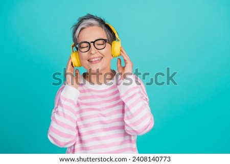 Photo of funky cheerful lady wear striped sweater closed eyes enjoying melody headphones empty space isolated turquoise color background Royalty-Free Stock Photo #2408140773