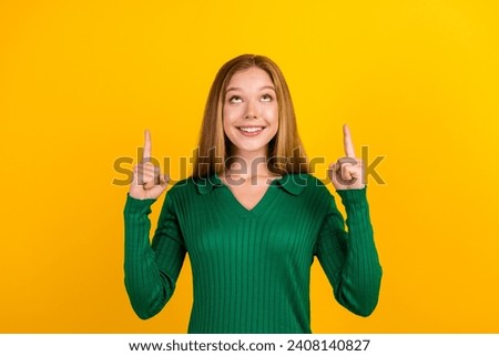 Portrait of cheerful nice person toothy smile look direct fingers up empty space isolated on yellow color background