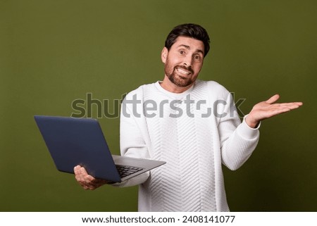 Photo of uncertain unsure man wear trendy white clothes shrugging shoulders misunderstanding isolated on khaki color background Royalty-Free Stock Photo #2408141077