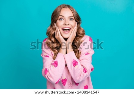 Portrait of young funky brown hair charming model girlfriend touch cheeks crazy emotions in good mood isolated on blue color background