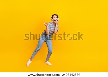 Full size photo of carefree positive girl demonstrate heavy metal symbol empty space isolated on yellow color background Royalty-Free Stock Photo #2408142839