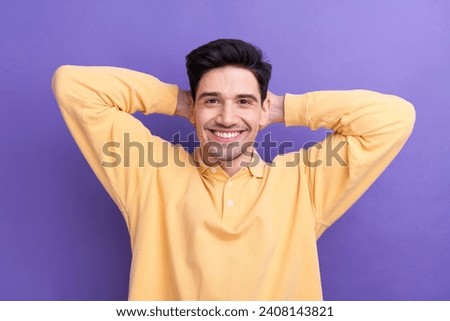 Photo portrait of attractive young man hands behind head have rest wear trendy yellow clothes isolated on violet color background