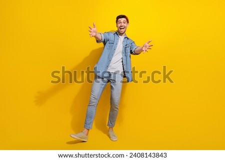 Full length photo of funny excited man dressed jeans shirt open arms ready hug you isolated yellow color background Royalty-Free Stock Photo #2408143843