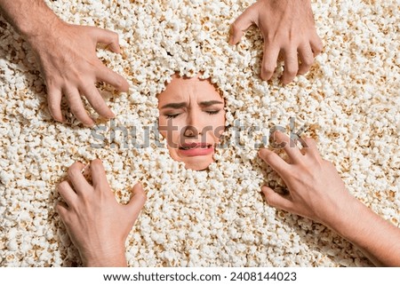 Above view photo of terrified girl closed eyes cry zombie people hands face inside full with popcorn background