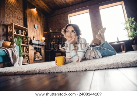 Full length photo of minded pretty person lying comfy carpet floor drink coffee inspiration spacious modern flat indoors Royalty-Free Stock Photo #2408144109