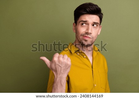 Profile portrait of pensive minded person look direct thumb finger empty space decide isolated on khaki color background