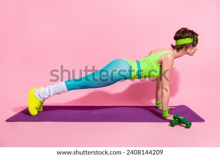 Full body profile photo of determined lady doing intense push ups fitness carpet isolated on pink color background