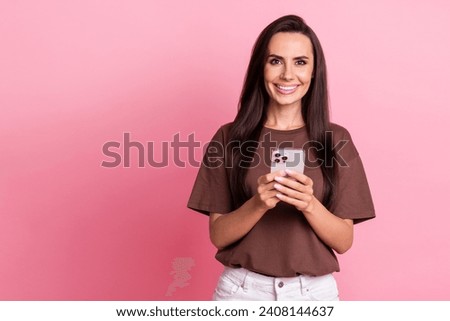 Portrait of young blogging optimistic cheerful businesswoman surfing internet browsing instagram reels isolated on pink color background Royalty-Free Stock Photo #2408144637