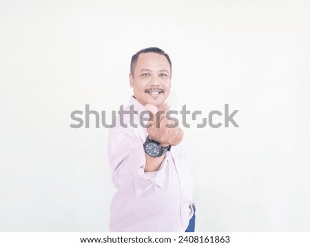 A brown-skinned Asian man wearing a pink shirt with a white background