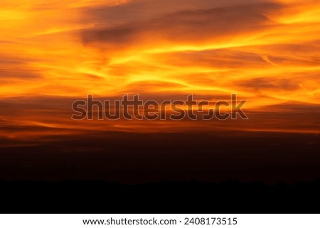 Dramatic red sky as background with dark black ground