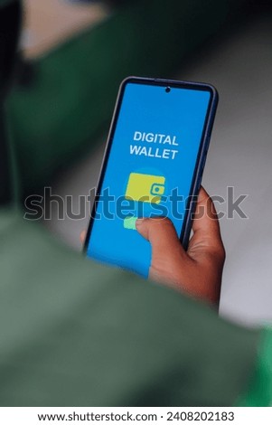 Close-up of Person's Hand Showing Digital Wallet Apps interface on Smartphone Screen