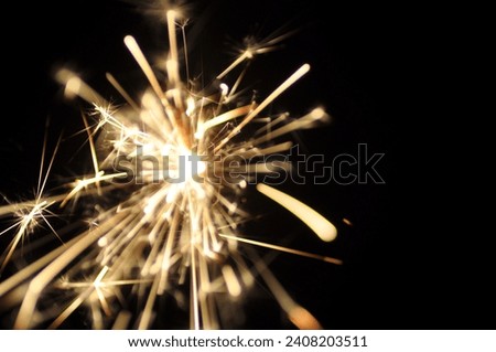 Golden sparkler on black. Bright sparklers on black background closeup