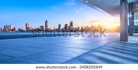 Empty square floor and city skyline with modern buildings at sunset in Shanghai. Panoramic view.