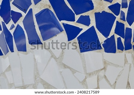 Colourful mosaic of broken tiles in blue and white colours. Photo for backdrop and background.
