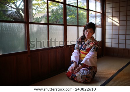 Japanese girl wearing kimono  , sitting and smile to  you
